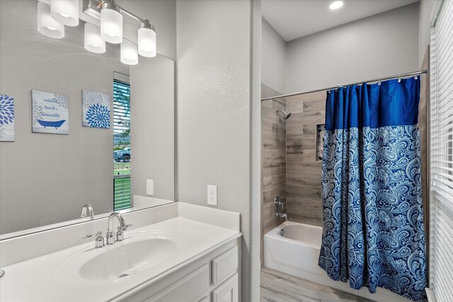 bathroom with vanity, hardwood / wood-style flooring, and shower / bath combo