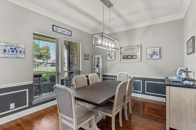 dining space featuring dark wood-type flooring, a notable chandelier, and ornamental molding