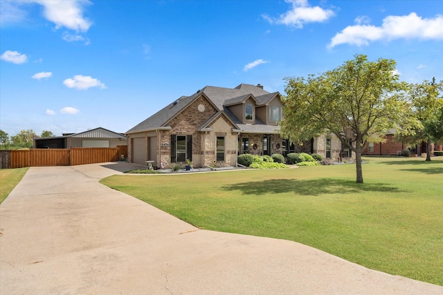 view of front facade with concrete driveway, brick siding, fence, and a front lawn