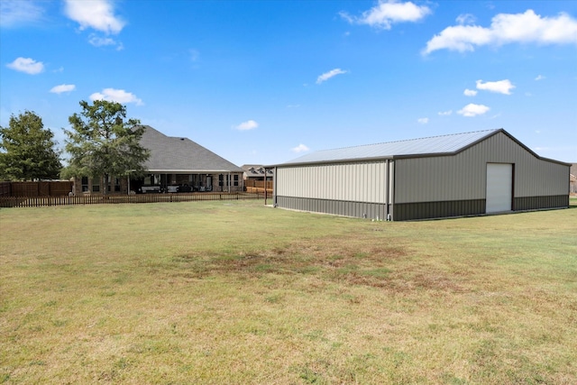 view of yard featuring an outbuilding and fence