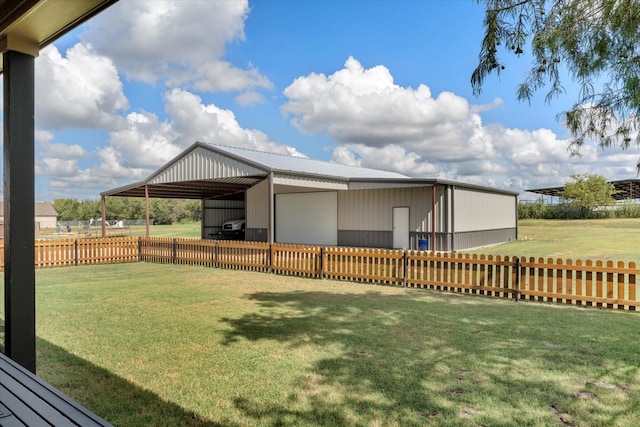 view of yard featuring an outbuilding and fence