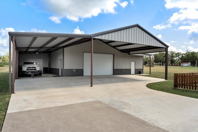 view of parking / parking lot with a lawn, a carport, and a garage