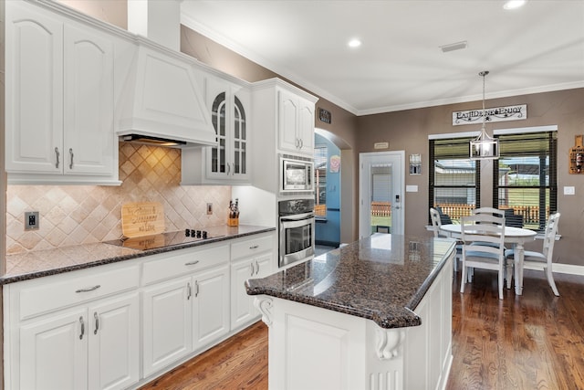 kitchen featuring dark hardwood / wood-style flooring, decorative light fixtures, stainless steel appliances, and white cabinets