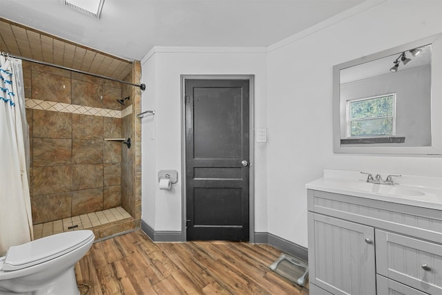 bathroom featuring toilet, ornamental molding, hardwood / wood-style floors, and a shower with curtain