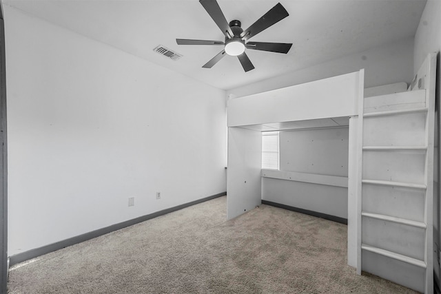 unfurnished bedroom with ceiling fan and light colored carpet