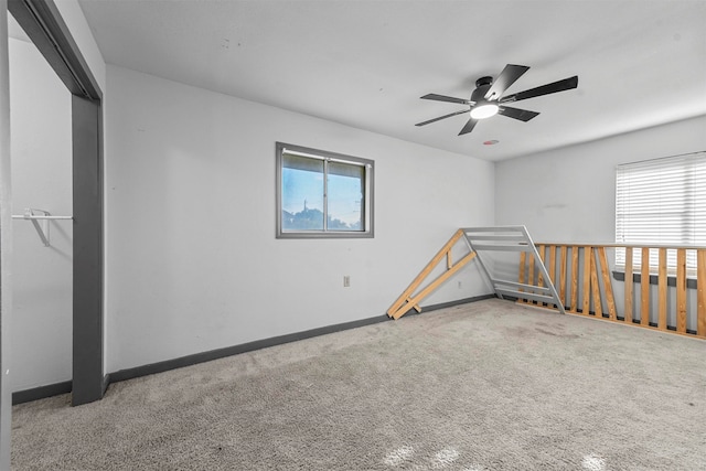 empty room with carpet floors and ceiling fan