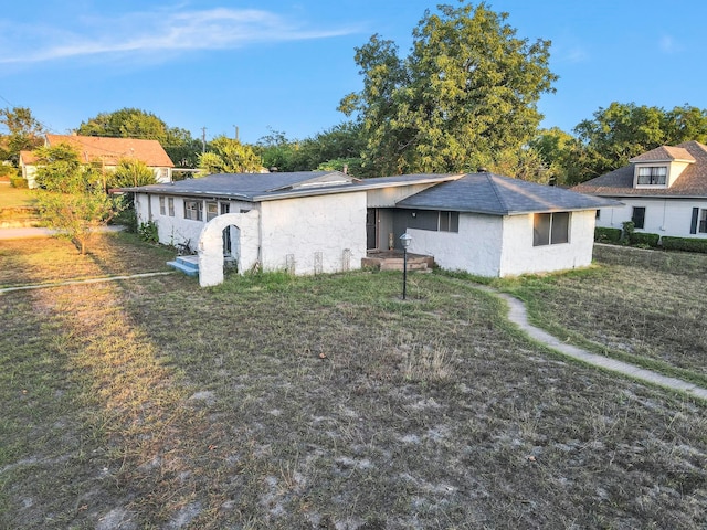 rear view of property featuring a yard