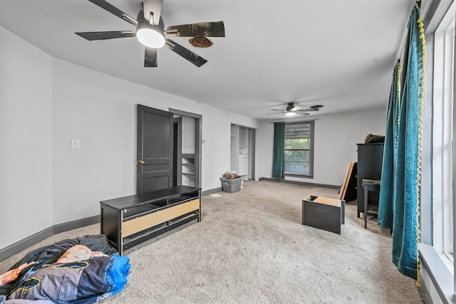 living room with ceiling fan and carpet