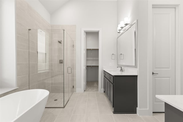 bathroom featuring tile patterned floors, vanity, lofted ceiling, and shower with separate bathtub