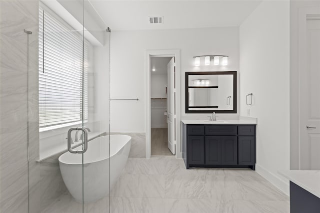 bathroom featuring vanity and tiled bath