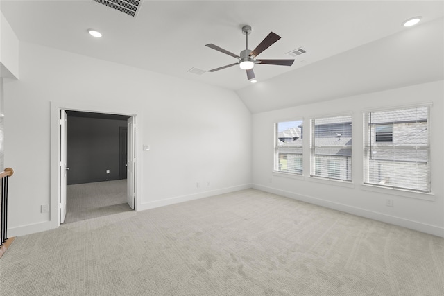 carpeted spare room featuring lofted ceiling and ceiling fan