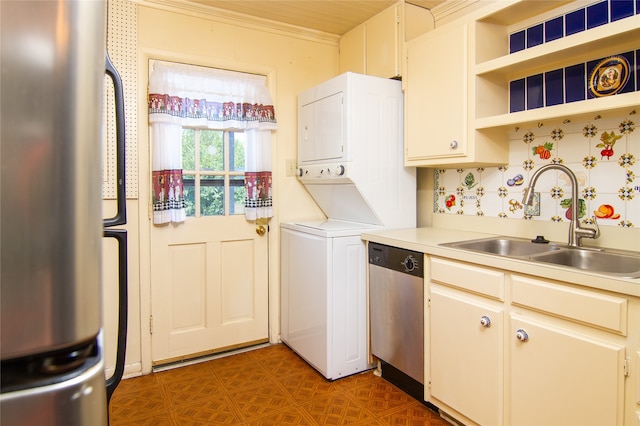 clothes washing area featuring crown molding, sink, and stacked washer / drying machine