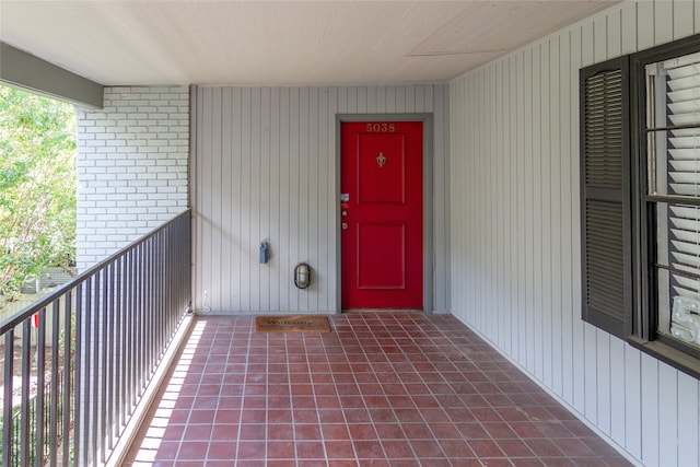 view of exterior entry featuring a balcony