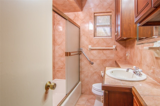 full bathroom with vanity, toilet, and tile walls