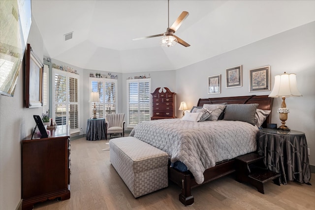 bedroom with ceiling fan, light wood-type flooring, and lofted ceiling