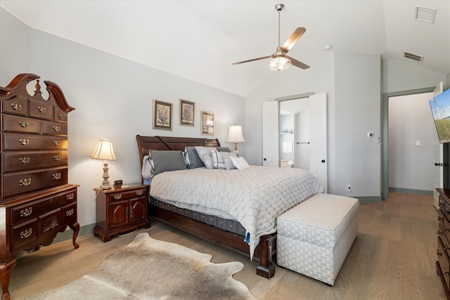 bedroom with light hardwood / wood-style flooring, vaulted ceiling, and ceiling fan