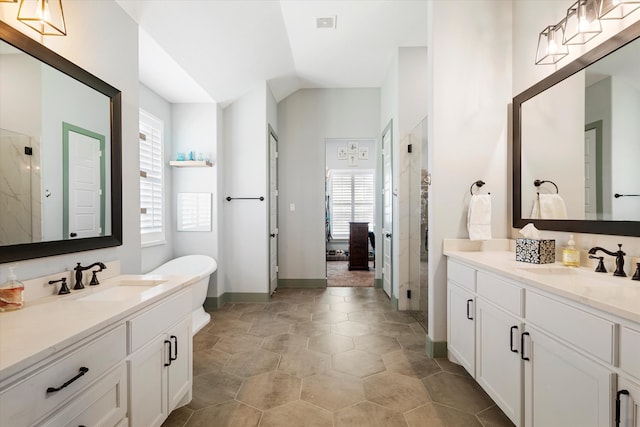 bathroom featuring tile patterned flooring, vanity, and a shower with door