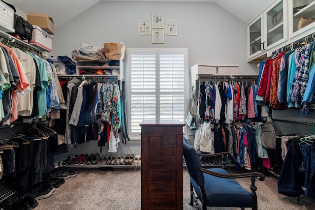 walk in closet with carpet floors and vaulted ceiling