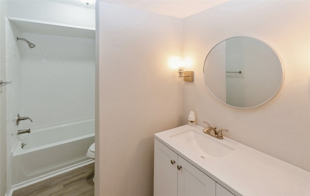 full bathroom with bathtub / shower combination, wood-type flooring, toilet, and vanity