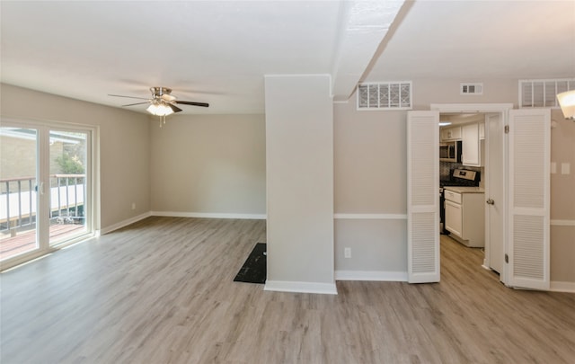 empty room featuring ceiling fan and light hardwood / wood-style floors