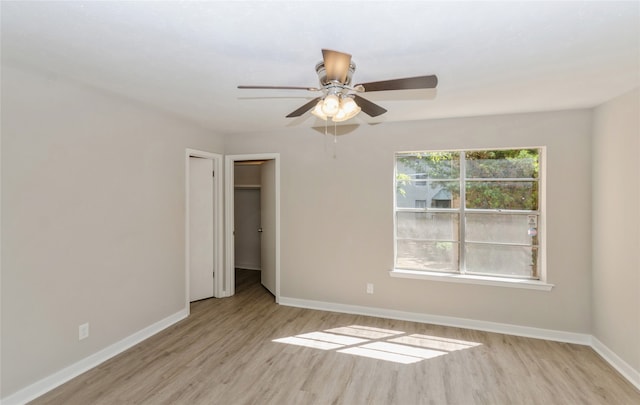 spare room featuring light hardwood / wood-style flooring and ceiling fan