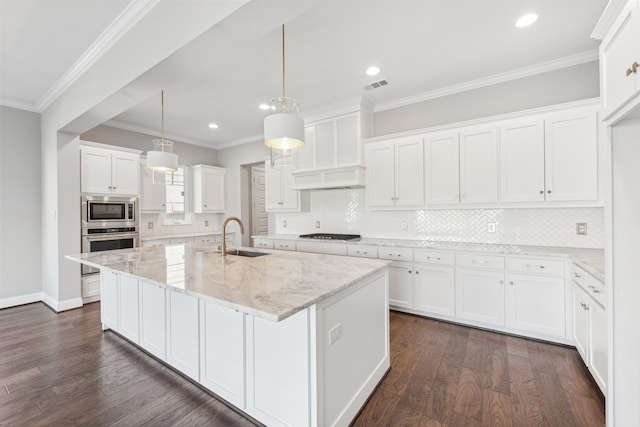 kitchen with dark wood finished floors, stainless steel appliances, visible vents, white cabinetry, and a sink