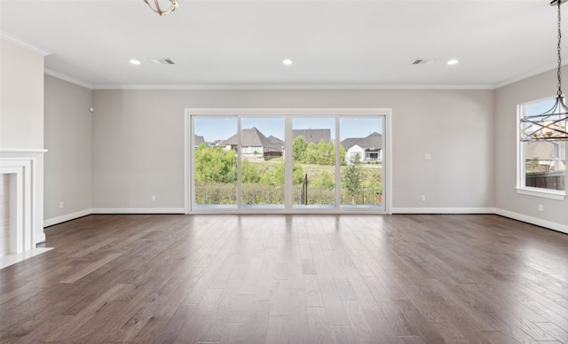 unfurnished living room with a fireplace, crown molding, and dark wood-type flooring