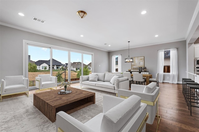 living area featuring ornamental molding, recessed lighting, wood-type flooring, and visible vents