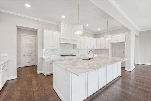 kitchen featuring dark wood-type flooring, white cabinetry, a sink, and gas cooktop