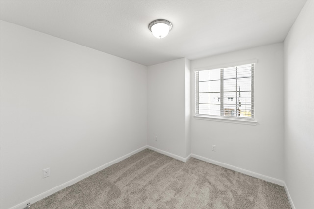 unfurnished room featuring light colored carpet