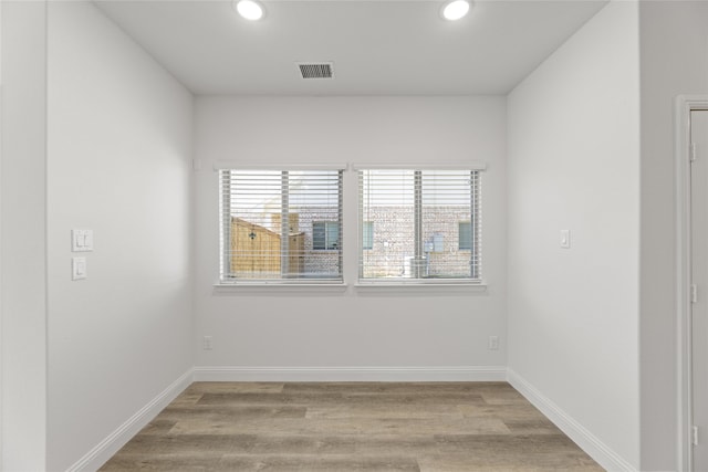 unfurnished room with light hardwood / wood-style floors