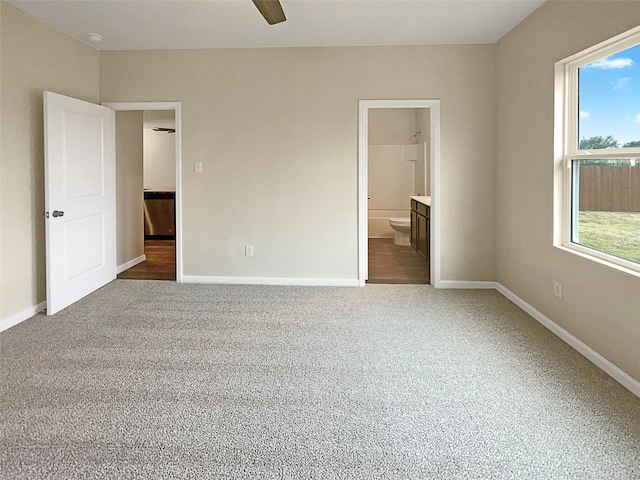 unfurnished bedroom featuring connected bathroom, ceiling fan, and carpet flooring