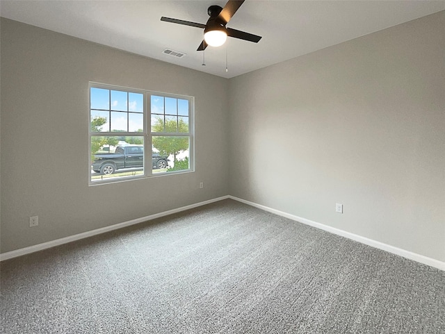 unfurnished room featuring visible vents, baseboards, ceiling fan, and carpet flooring