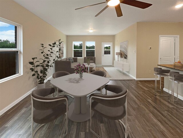 dining area featuring dark wood-type flooring and ceiling fan