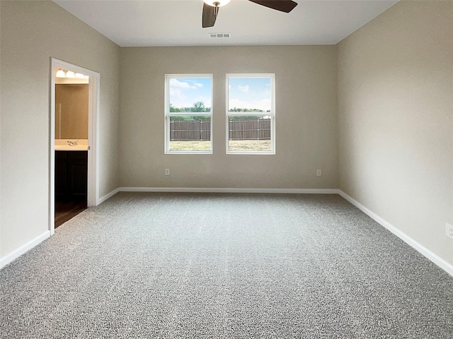 unfurnished bedroom featuring carpet flooring, visible vents, connected bathroom, and baseboards