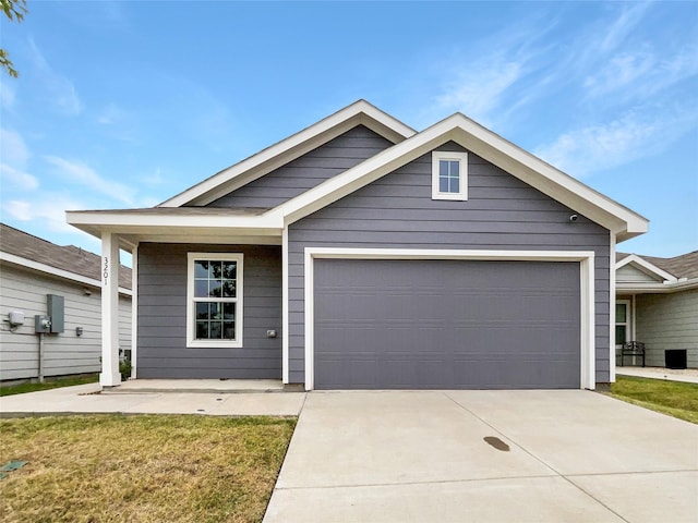 view of front facade featuring concrete driveway, a garage, and a front yard