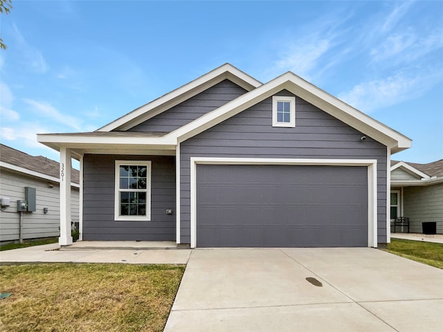 view of front of property with a garage and a front lawn