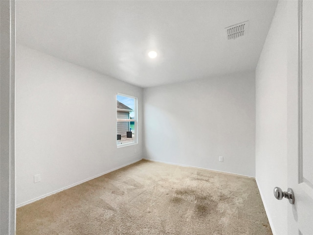 carpeted spare room with visible vents