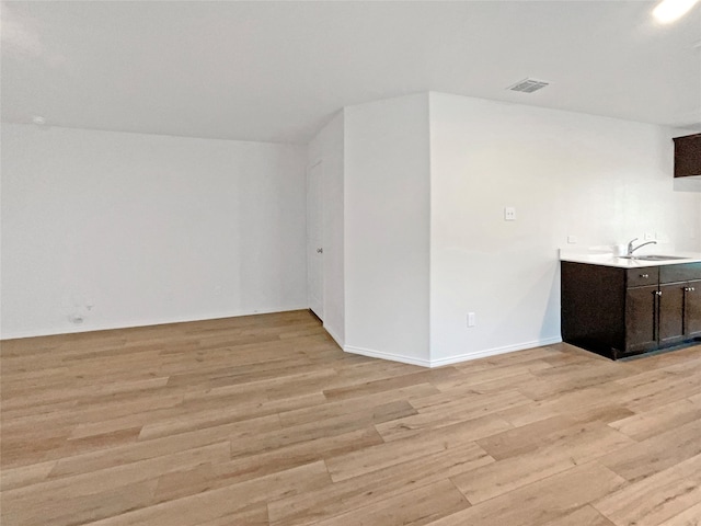 empty room featuring light hardwood / wood-style floors and sink