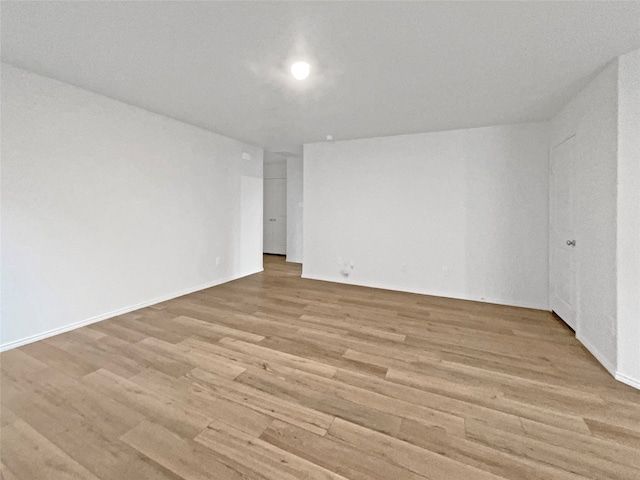 spare room with light hardwood / wood-style flooring