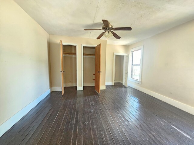 unfurnished bedroom featuring ceiling fan and dark hardwood / wood-style flooring