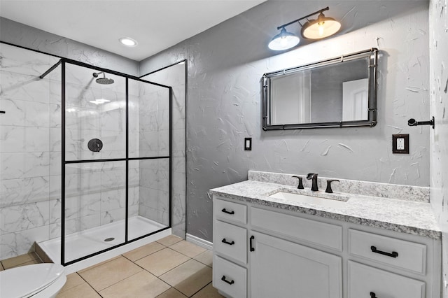 91 Pecan Dr, Pottsboro, TX 75076 - full bathroom featuring vanity, a shower stall, toilet, tile patterned flooring, and a textured wall