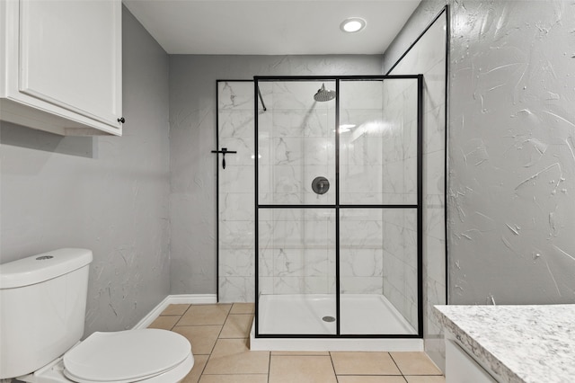 bathroom with vanity, toilet, a shower with door, and tile patterned floors