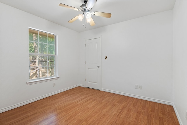 spare room featuring light hardwood / wood-style flooring and ceiling fan