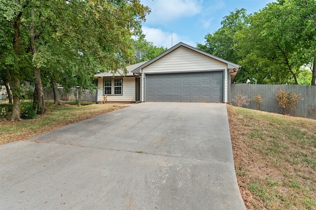 ranch-style house featuring a front yard and a garage