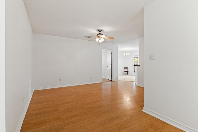 91 Pecan Dr, Pottsboro, TX 75076 - empty room featuring ceiling fan, a chandelier, light wood-style flooring, and baseboards