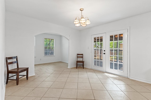 91 Pecan Dr, Pottsboro, TX 75076 - doorway to outside featuring french doors, a chandelier, arched walkways, light tile patterned floors, and baseboards