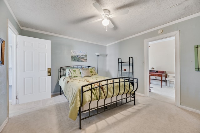 carpeted bedroom with a textured ceiling, crown molding, and ceiling fan