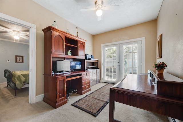 office with ceiling fan, crown molding, light carpet, and french doors