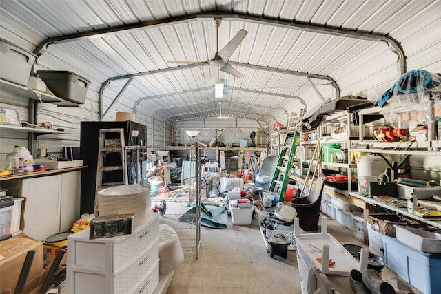 garage with ceiling fan and wooden walls